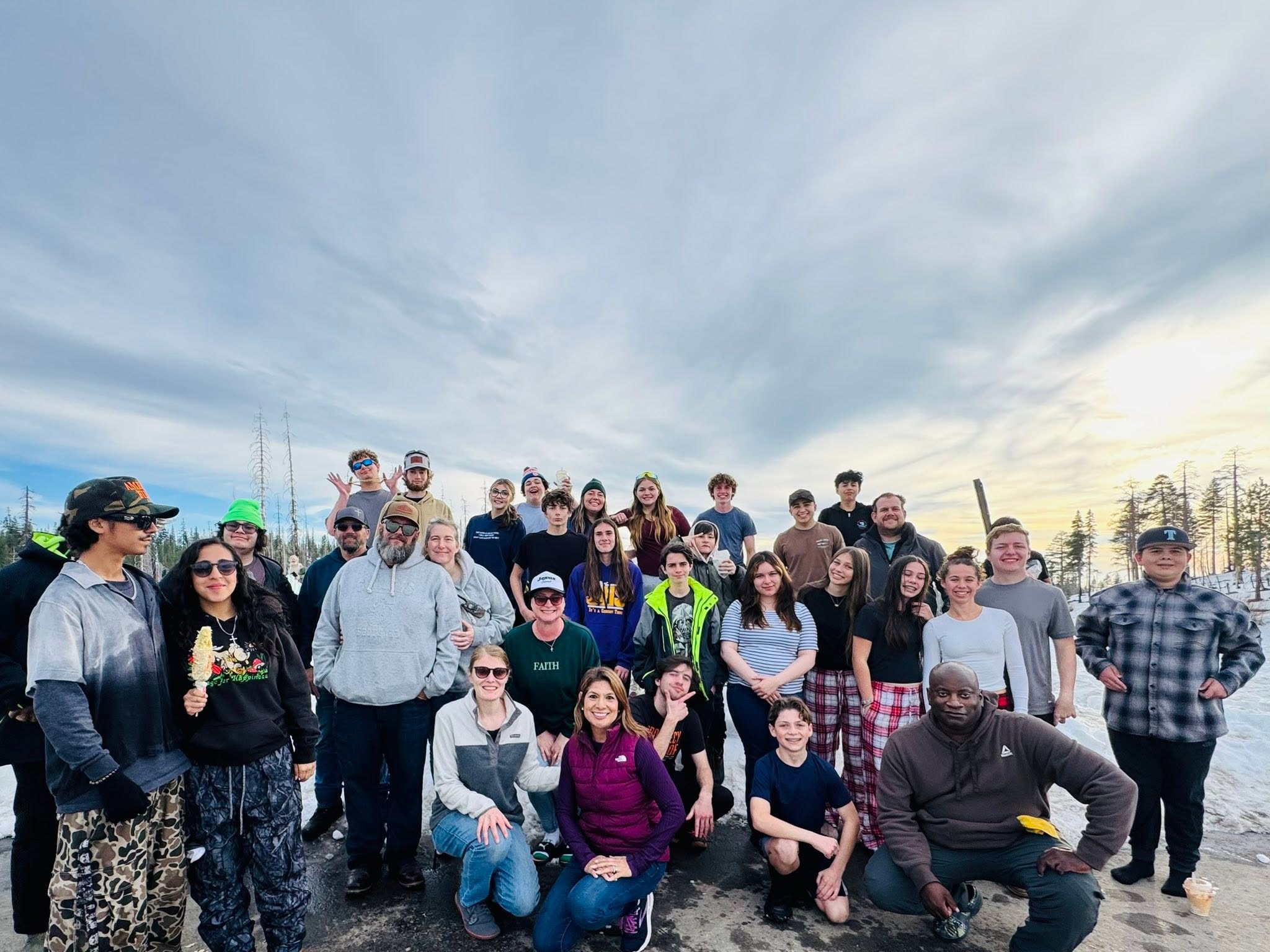 Journey student ministry group photo on a mountain trip at sunset